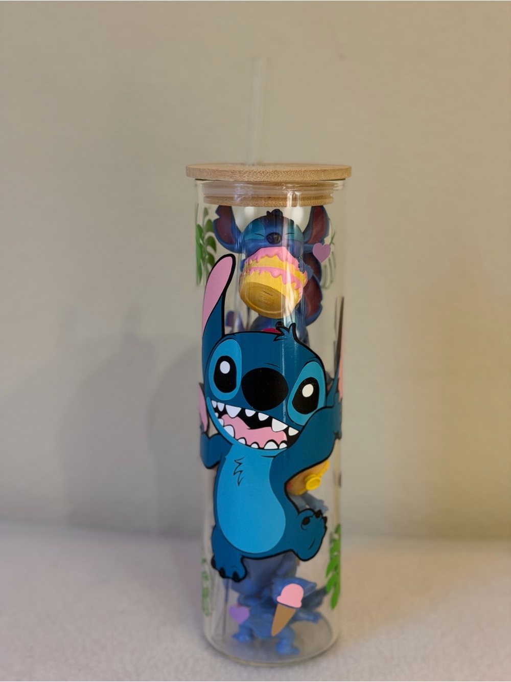 Stitch Glass Water Bottle with Straw and wooden lid, filled with snitch trinkets